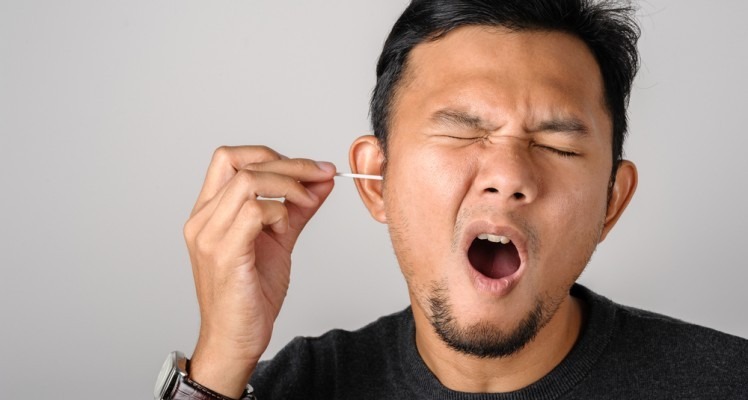 guy with cotton swab in ear